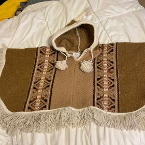 Childs poncho with Hood, tassel hanging on the top of the hood , tassels at neck